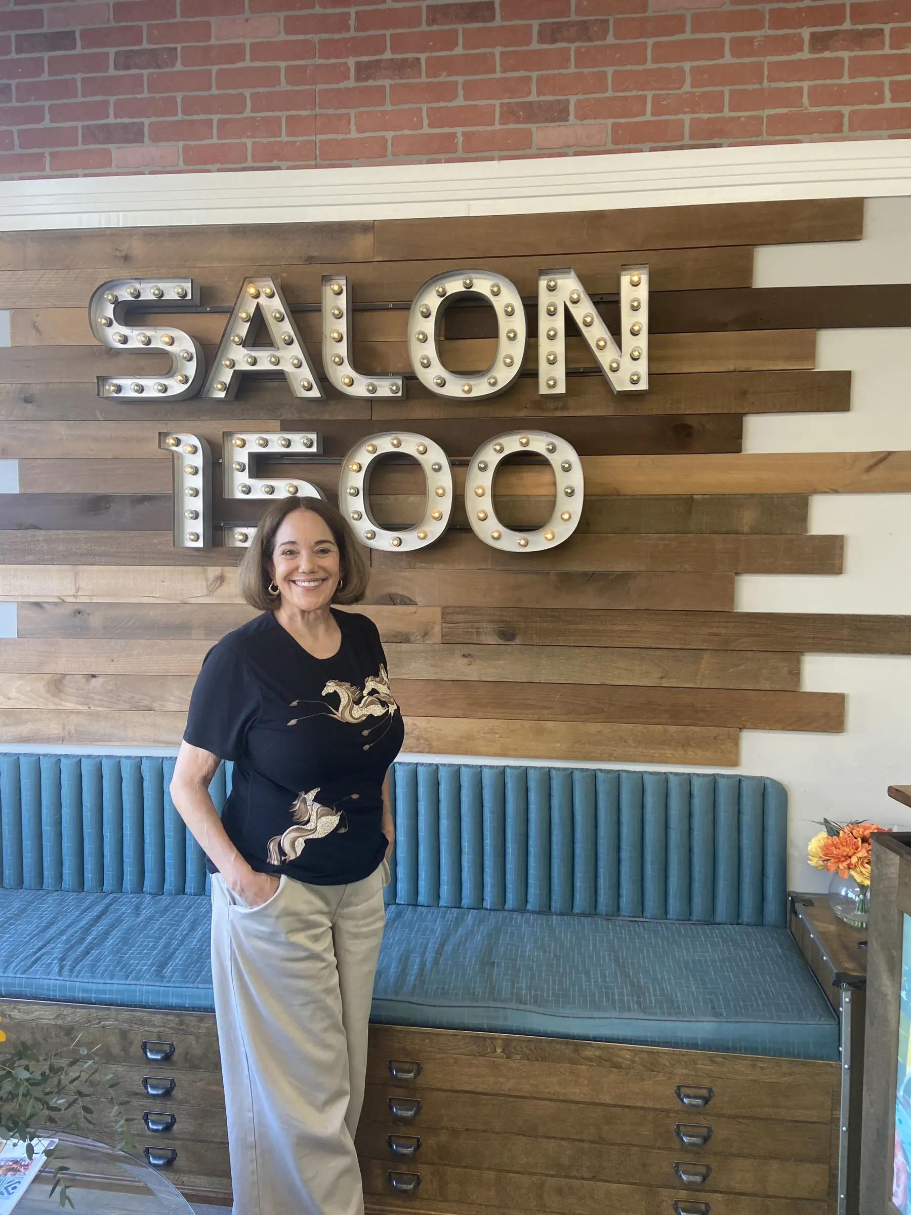 Maria Bondonno standing and smiling at Salon 1500 in Alameda